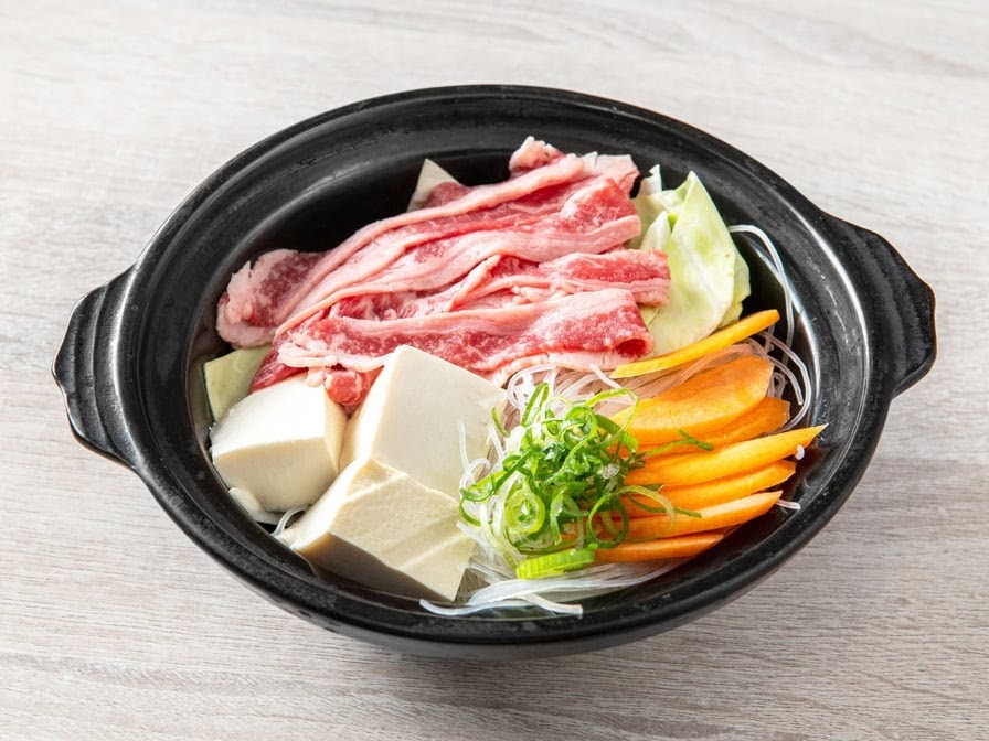 Hotpot with sliced beef, tofu, carrot, cabbage and glass noodles